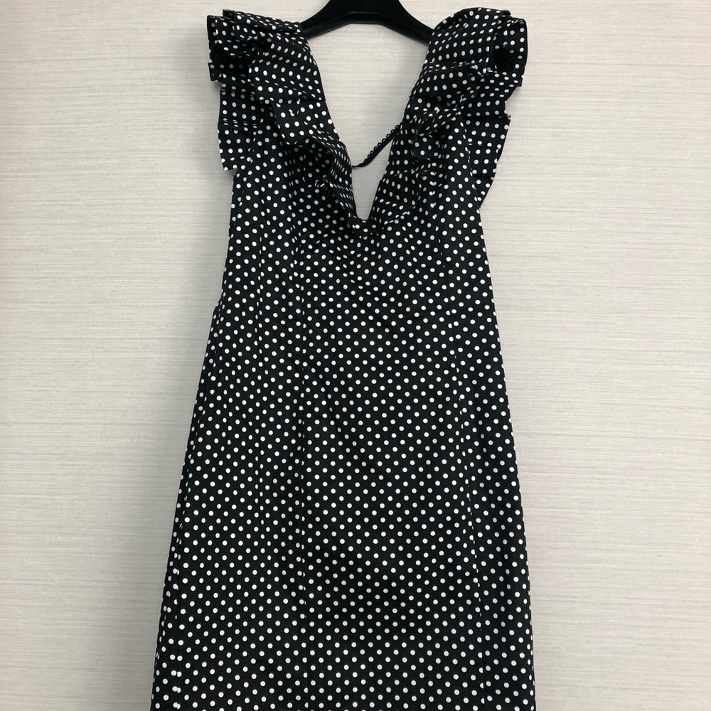 Black open-back polka dot dress with ruffle sleeve